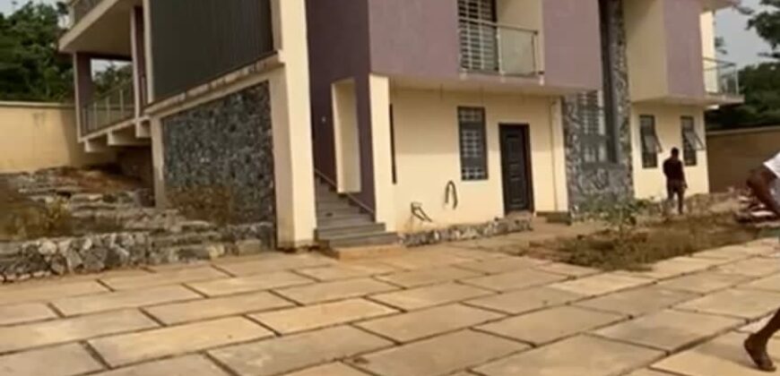 Alert ultra modern 4 bedroom house with BQ , security post situated on 1.5 plots of land underground basement now selling at Aburi